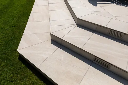 Close-up of Allora Bianco porcelain, highlighting smooth texture and delicate veining, ideal for contemporary designs.