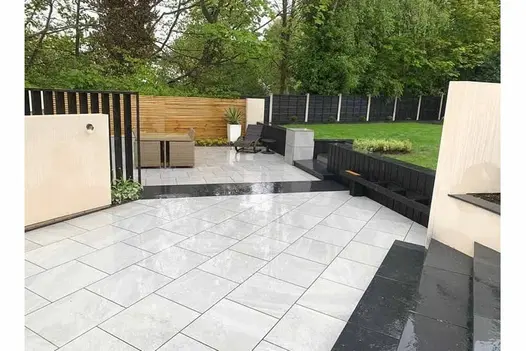 Wet and shining Allora Silver 600x600 porcelain paving creates a crisp and modern patio with a soft silver hue.