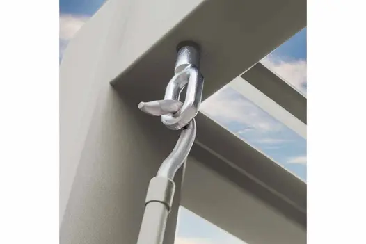 Close-up of corner of white powder-coated aluminium frame of Proteus Metal Pergola, crank handle in hook ready to open louvres.