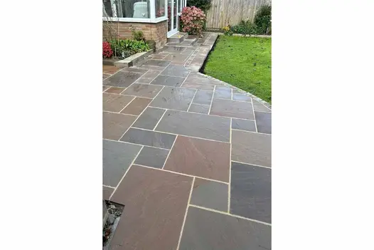 Traditional patio design using Autumn Brown Sandstone patio pack, with warm earthy tones and a riven texture.