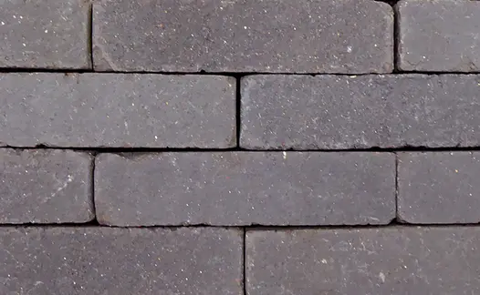 Close up view of the charcoal grey clay paving where you can see these brick pavers flecks of light within the grey.