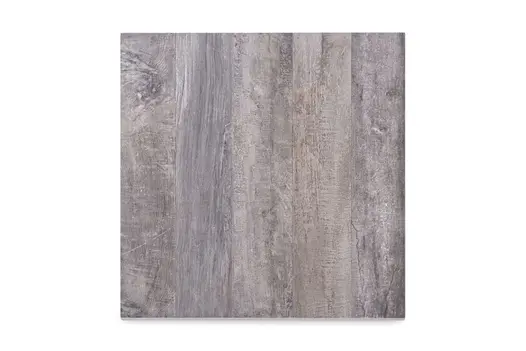 Close-up swatch of Cinder Wood Porcelain Paving, showing mixed grey tones and realistic wood-grain effect.