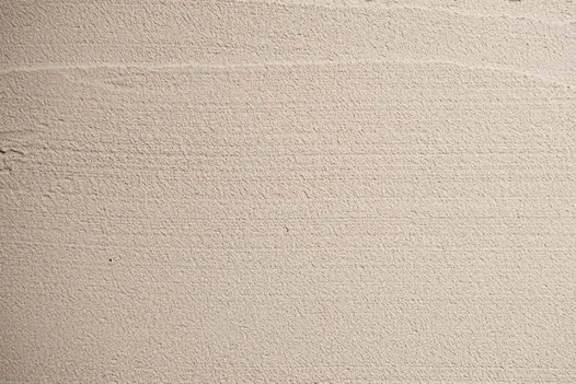 A detailed view of PorTec External Porcelain Grout in an ivory shade, showcasing its smooth texture.