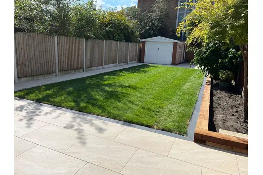Long garden path laid with County Cream Porcelain Paving, bordered by lawn and timber edging.