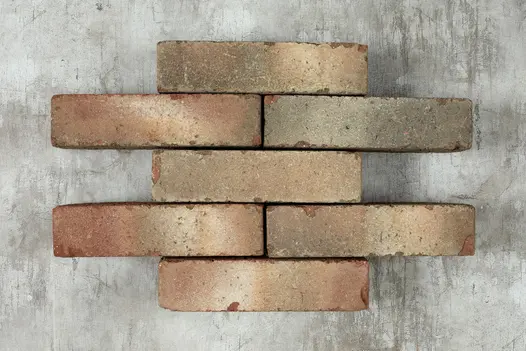 7 Bexhill clay pavers laid in alternating rows of 1 and 2 bricks, showing red and grey colours and tumbled edges.