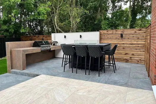 Warm-toned Gaja Beige 900x600 porcelain paving in a soft stone-effect finish, perfect for a relaxed patio setting.
