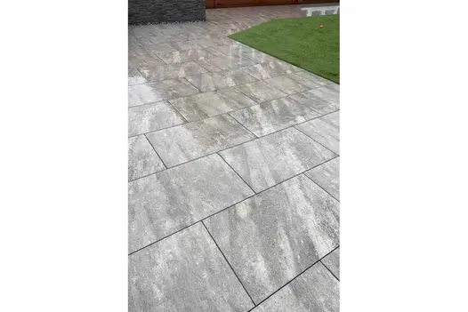 Quartz Grey 900x600 porcelain paving used in a modern garden, providing a soft grey tone with a lightly textured surface.