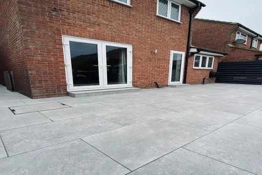 Spacious rear patio in Heritage Grey Porcelain, creating a clean and simple finish to the garden.