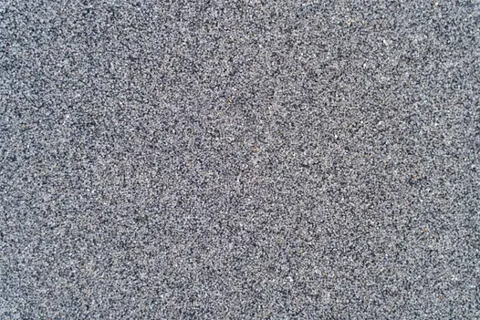A close-up of grey-coloured JointTec brush-in jointing compound, displaying its granular texture.