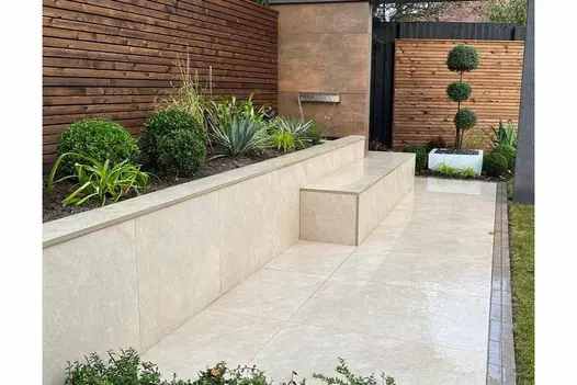 Built-in bench and planter setup finished with White Quartz porcelain paving tiles.