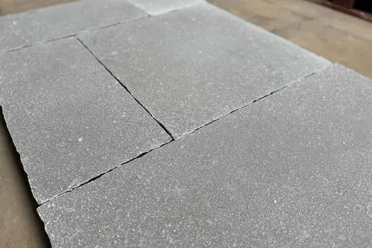 Close-up of Antique Grey Limestone paving showing the textured surface, natural variation, and hand-cut edges.
