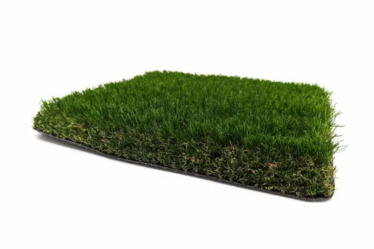 A cut piece of artificial grass roll, showcasing the pile height and realistic brown thatch layer.
