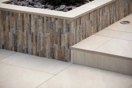 Close-up of Ocean Quartz Wall Cladding, featuring textured natural stone in lots of varied earthy tones.