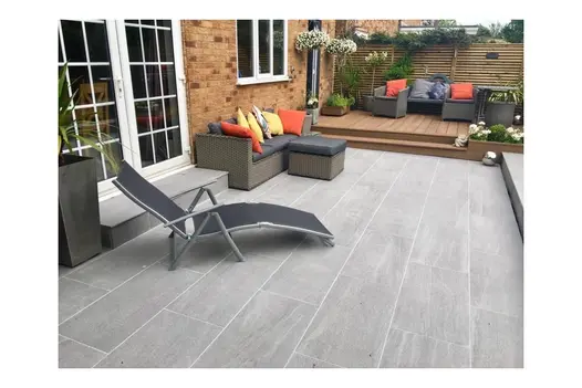 Relaxed patio area with Overland Silver 900x450 Porcelain, ideal for sun loungers and outdoor entertaining.