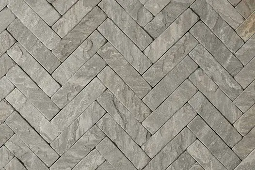 Detailed view of Tumbled Black Sandstone Pavers, showcasing the natural variations and weathered appearance of the stone pavers employed as patio bricks.