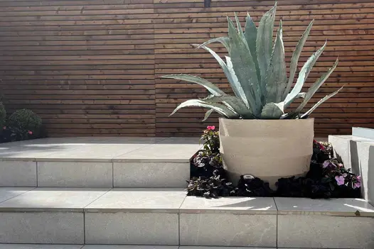 Elegant garden steps and planters built with pumice porcelain paving throughout.