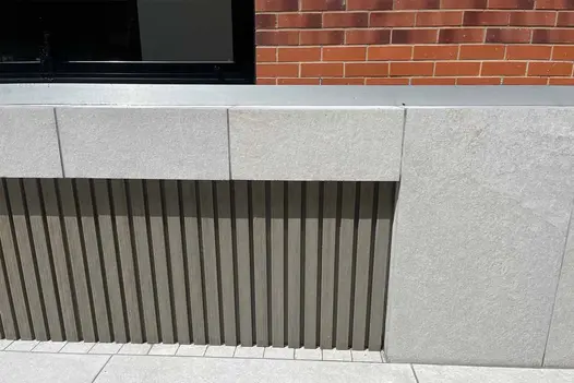 Porcelain paving in pumice tones adds clean structure to this modern garden patio.