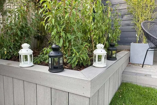 Pebble Grey Brushed DesignBoard fascia installed on a raised planter with modern outdoor décor.”