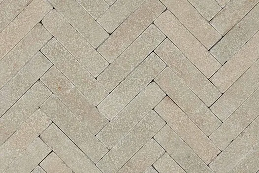 View directly down onto Antique Yellow limestone pavers laid in herringbone pattern without joints. Free UK delivery available.