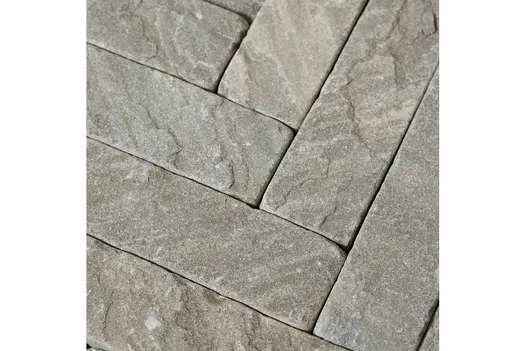 Close-up shot of Tumbled Black Sandstone Pavers, revealing the rugged texture and dark hues of the stone pavers used as patio bricks.