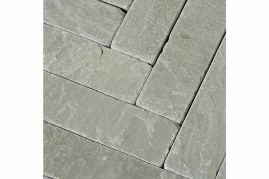 Close-up shot of Tumbled Kandla Grey Sandstone Pavers, showcasing the texture and detail of the stone pavers used as patio bricks.