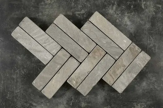 12 Tumbled Mint patio bricks, arranged in a herringbone pattern with 3 double courses of 2 patio bricks each.